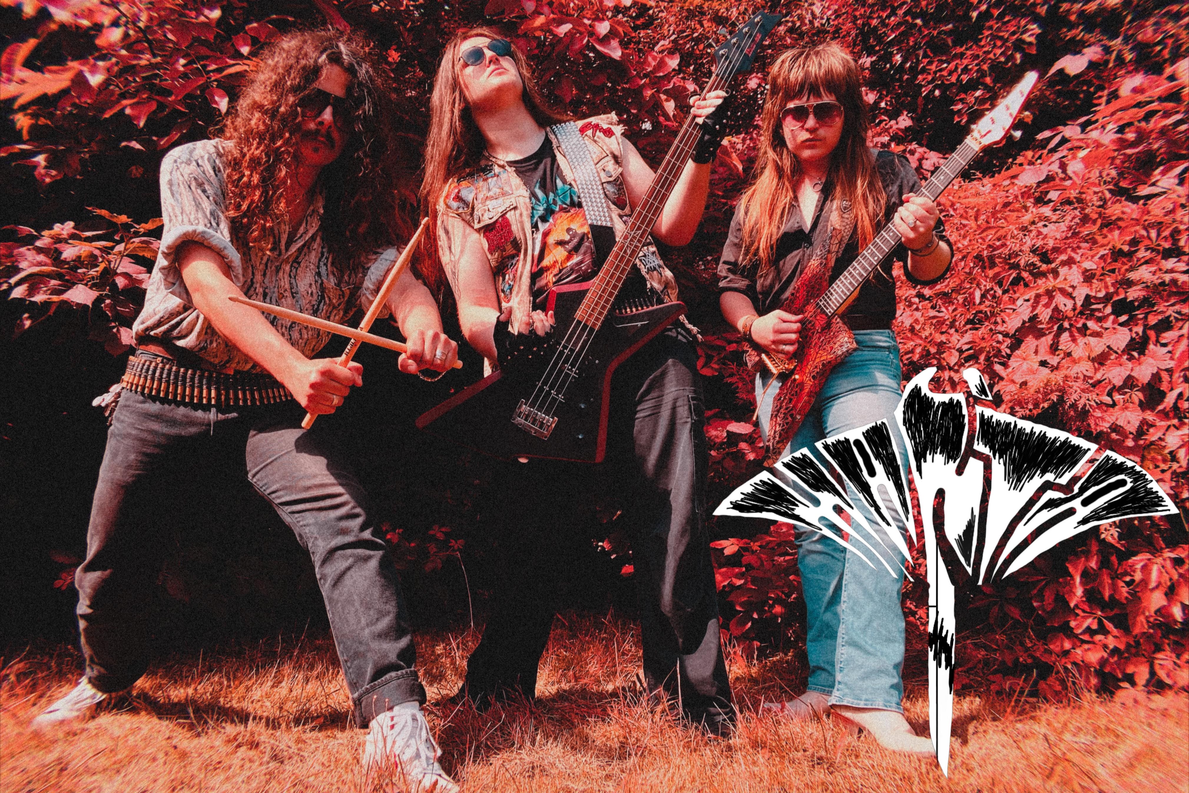 Band photo from the band Manta.
Three guys with long hair and sunglasses and jeans.
The two on the left and right are wearing shirts. The one in the middle is wearing a band shirt with his cowl on top.
The one on the left holds his drumsticks crosswise. In the middle he plays his bass and on the right he plays his guitar.
Bushes in the background.
The whole photo has a strong red cast.
In the right corner is the band logo.
The lettering "Manta" in black and white in form of a manta.